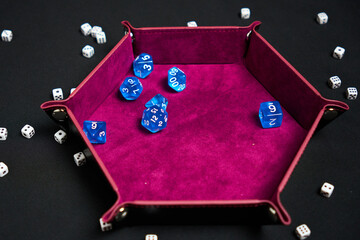 dice in a leather bowl with red velvet