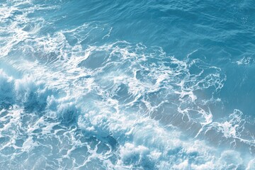 Obraz premium High-angle view of crashing waves. A pattern of foamy white crests on a deep, vibrant blue sea