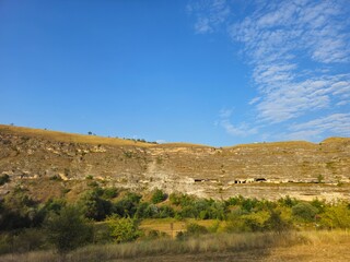 A landscape with a hill and trees