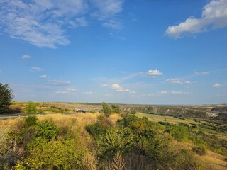 A landscape with trees and a blue sky