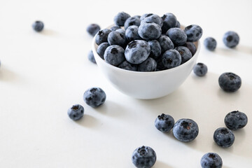 Blueberry is tasty, healthy and delicious fruits. Fresh blueberries  in white bowl. Wild blueberries in white plate on white background.