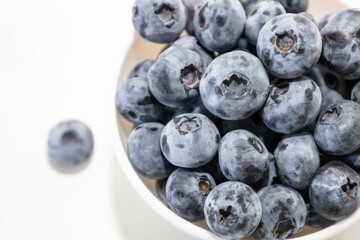 Blueberry is tasty, healthy and delicious fruits. Fresh blueberries  in white bowl. Wild blueberries in white plate on white background.