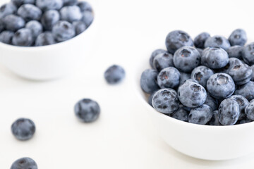 Blueberry is tasty, healthy and delicious fruits. Fresh blueberries  in white bowl. Wild blueberries in white plates on white background.