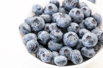 Blueberry is tasty, healthy and delicious fruits. Fresh blueberries  in white bowl. Wild blueberries in white plate on white background.