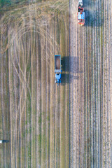 A rural landscape with a tractor and harvester from above. A Rural Landscape Drone