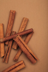 Cinnamon sticks dried tree bark spice on brown background.