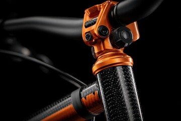 Obraz premium Close up on orange metallic bicycle stem and handlebars with carbon fiber elements