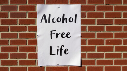 Fototapeta premium A poster titled “Life Without Alcohol” displayed on a brick wall to raise awareness about sobriety and combat alcoholism.
