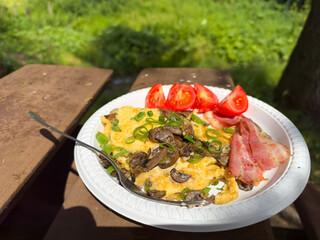 A plate of delicious food with eggs, bacon, and tomatoes