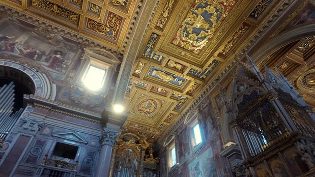 Basilica of St. John Lateran interior with gilded coffered ceiling, frescoed walls, and medieval ciborium above the high altar