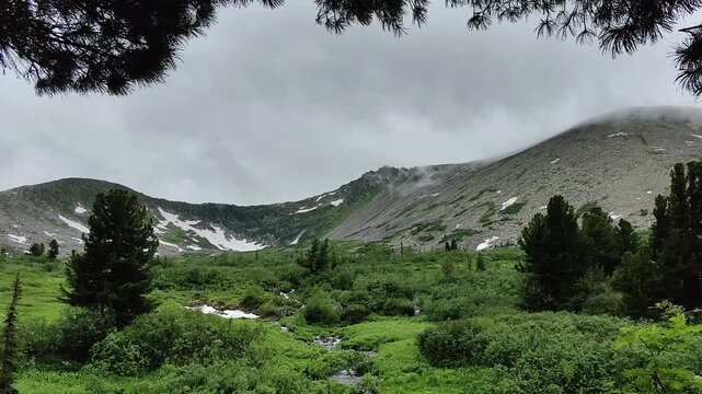 Dramatic mountain landscape with clouds creates a captivating natural vista.