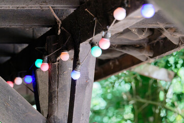 Old wooden shelter with lights and thick white spiderwebs