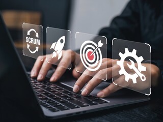 Hands working on laptop with Scrum process icons, achieving goals through modern teamwork
