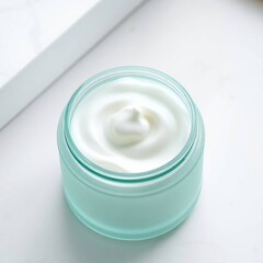 Creamy lotion in teal jar.