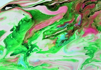 abstract background of colored oil paint in different shades of green and pink