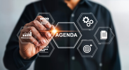 Businessman touching a digital interface with icons representing business agenda, planning, goals, progress, and reports, symbolizing strategic business management and success