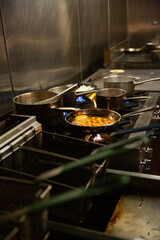Chef prepares food on a stove top