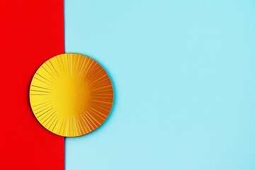 A gold sunburst medal partially covered by a red ribbon on a light blue background with copy space. Concept of award, achievement, celebration, vibrant.