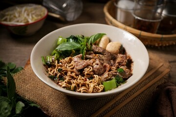 Noodle soup with sliced pork, pig blood, meatball and Thai morning glory,Nam Tok noodles with instant noodles