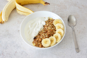 a Breakfast Bowl with Banana slices, Yogurt and Granola decorated with banana