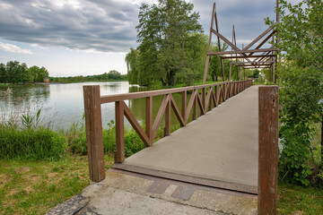 Wooden footbridge over Boating lake in park. Nagykanizsa, Hungary.