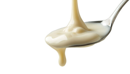Condensed milk flowing down from a metal spoon isolated on a transparent background