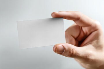 Obraz premium Hand Holding Blank Business Card Mockup on White Background