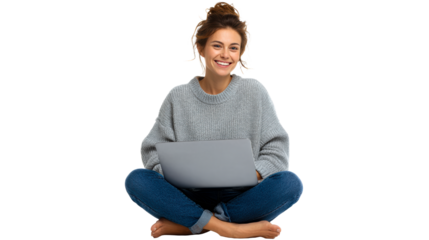 Woman in grey sweater and jeans sitting cross-legged with laptop