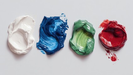 Four paint swatches, white, blue, green, and red, arranged in a row on a white background.  The paints have a thick, impasto texture