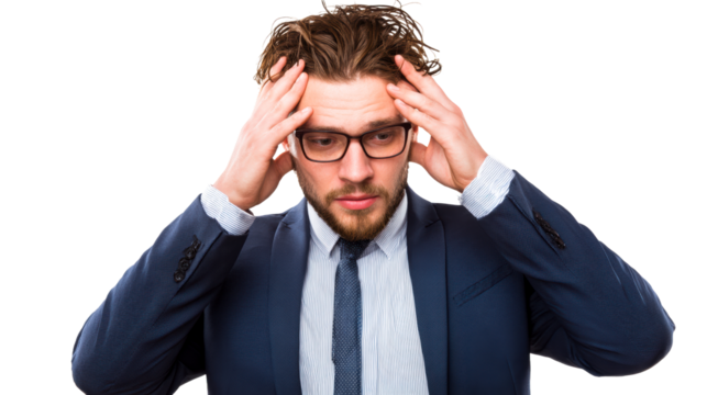 Man in Suit Rubbing Temples with Hands Looking Downward