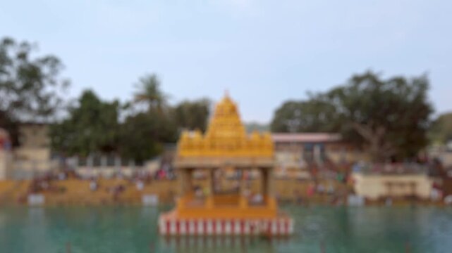 Bokeh view of Nitya Pushkarini temple, located near Sri Venkateswara Swamy Vaari Temple, Tirumala, Tirupati, India. Blurred background footage.