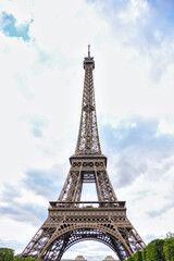 Fototapeta premium Iconic Eiffel Tower with cloudy sky Paris France