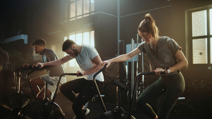 Athletes training using air bikes in crossfit gym: intense workout session