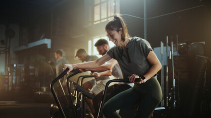 Athletes training on air bikes in modern gym: intense cardio workout for fitness enthusiasts