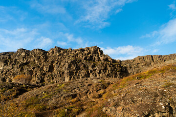 Rocky tectonic Almannagja mountain. Mountain geology rock. Geology rocky cliff. Cliff edge Almannagja. Mountain wall cliff in Iceland. Geological tectonic rock in nature of Iceland