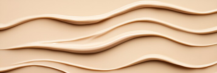 A smooth, flowing texture of a creamy substance, resembling waves, on a beige background, highlighting elegance and beauty.