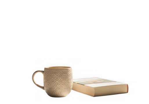A textured mug sits next to an open book on a transparent background