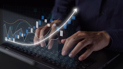 A close-up view of hands typing on a laptop keyboard, featuring an overlay of financial data graphs and an upward arrow, representing business growth and analysis. Copula