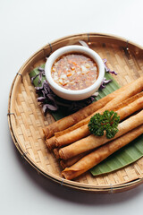 Crispy Fried Spring Rolls with Dipping Sauce on Bamboo Tray