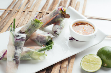 Fresh Spring Rolls with Spicy Dipping Sauce and Lime Wedges