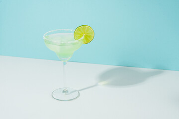 Margarita cocktail. Summer alcohol drink on blue background.