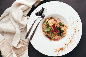 Overhead Shot of Ham and Herb Spaghetti on White Plate