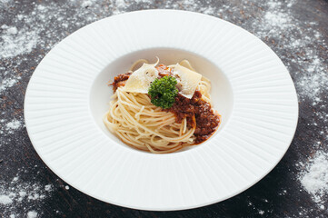 Spaghetti with Meat Sauce and Parmesan Cheese on White Plate