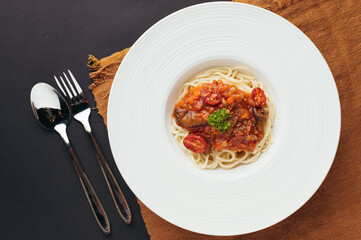 Spaghetti with Tomato Sauce and Parsley on White Plate