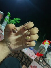 hand with money Earth tone manicure