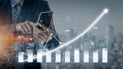 A businessman interacts with a smartphone while viewing financial data on digital charts and graphs against a modern urban backdrop, symbolizing growth and success. Copula