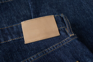 Tag or label on fabric jeans for shopping, sale and discount information. Blank template for branding and product presentation top view.