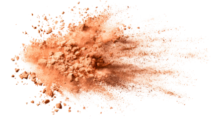Orange powder explosion with fine particles scattering across white
