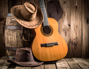 Cowboy hats with guitar, and barn wood.