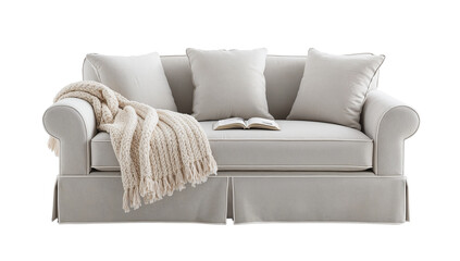 Elegant and inviting white sofa adorned with a cozy knit blanket and open book adding a touch of